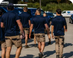 Plumbers walking to their service vans on a Chipping Norton job